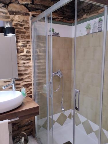 a shower with a glass door in a bathroom at Casa da Vita in Ferreira
