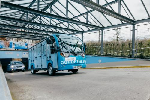 a blue bus is driving in a building at Aqua Blu Hotel in Bad Füssing
