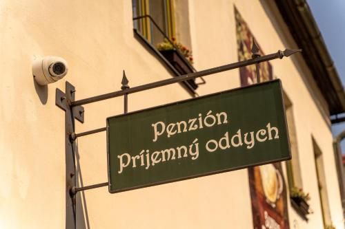 a green sign on the side of a building at Penzión Príjemný Oddych in Banská Štiavnica