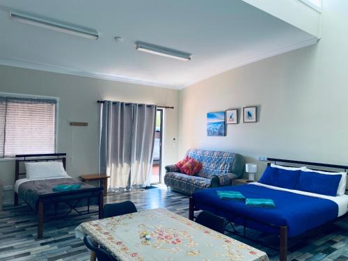 a living room with a bed and a couch at Sabai accommodation in Dongara