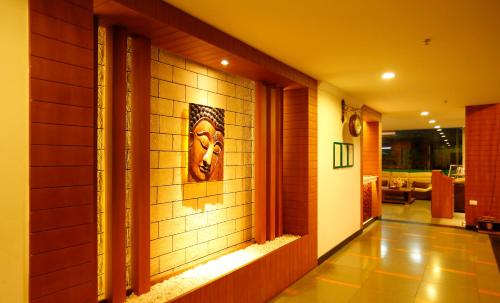 a tile hallway with a face on the wall at Spice Grove in Thekkady
