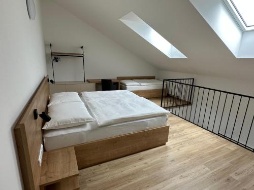 a bedroom with a bed and a skylight at Apartmány Lošov in Olomouc