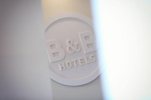 a close up of a bottle of baxter hotels logo at B&B HOTEL Metz Jouy Aux Arches in Jouy-aux-Arches