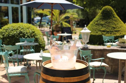 a bottle of wine in a glass on top of a barrel at Hotel Bernstein Prerow in Prerow