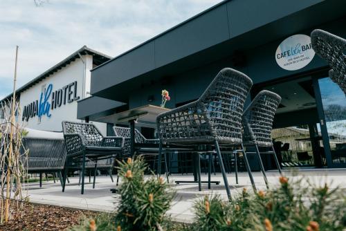 a group of chairs sitting outside of a building at Aqua Blu Hotel in Bad Füssing