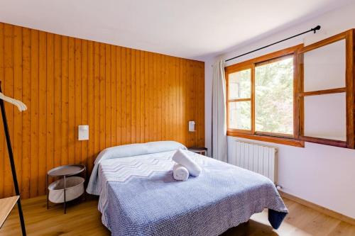 1 dormitorio con 1 cama con manta azul en Rural Hostel dos Lucas, en Biescas