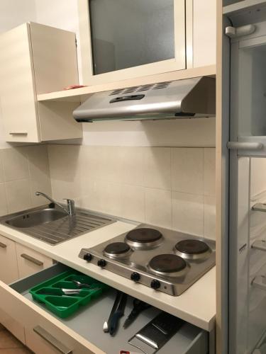 cocina con fogones y fregadero en Residence il Tombolo, en Principina a Mare