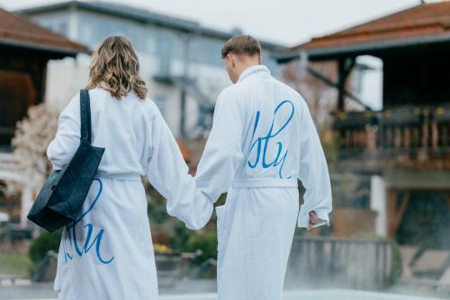 a man and a woman holding hands at Aqua Blu Hotel in Bad Füssing