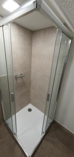 a shower with a glass door in a room at Druzicova in Banská Štiavnica