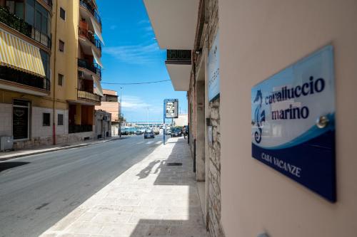 a street with a sign on the side of a building at Cavalluccio marino in Bisceglie