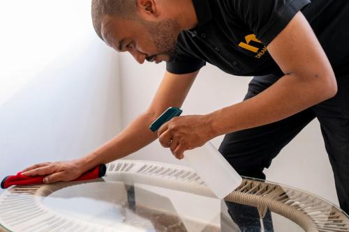 a man using asaw to clean a glass table at Dream House in 6th Of October