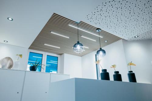 a kitchen with black vases on a white wall at Aqua Blu Hotel in Bad Füssing