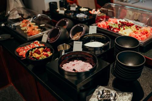 a buffet with different types of food on a table at Paulshöhe in Waren