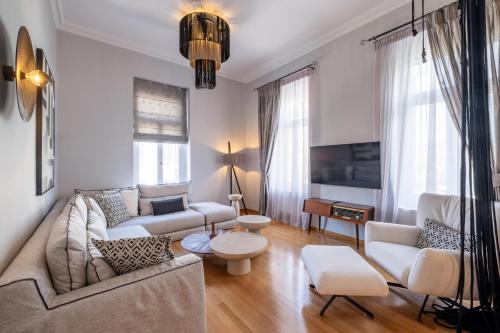 a living room with a couch and a tv at Thiseas Luxury Apartment in Athens