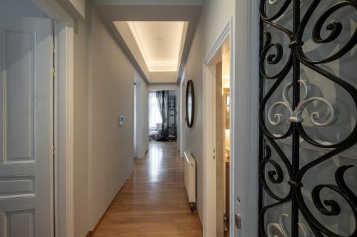 a hallway with a door with a wrought iron gate at Thiseas Luxury Apartment in Athens