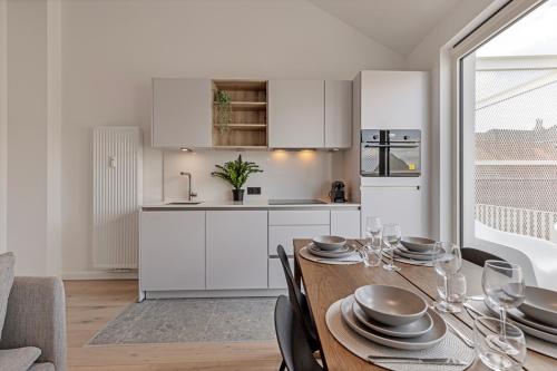 a kitchen and dining room with a table and chairs at Märch - Mechelen Goat 21 in Mechelen