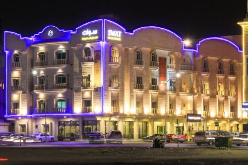 a building with blue lights on the front of it at Swat Hotel Apartments 2 in Al Khobar