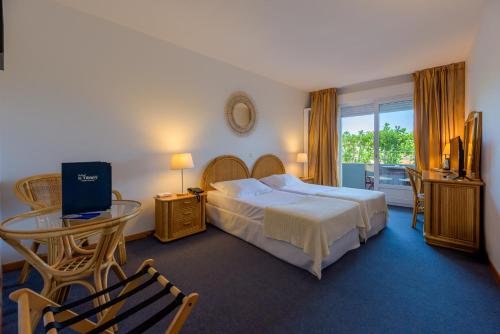 Postel nebo postele na pokoji v ubytování Hotel Le Tilbury