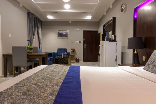 a hotel room with a bed and a desk and a refrigerator at شقق سوات للشقق المخدومة 2 in Al Khobar
