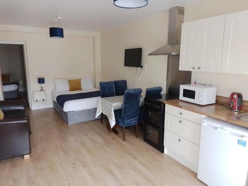 a small room with a bed and a kitchen at Tara View Apartments in Garristown