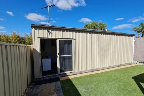 a large white shed with a large door at Esplanade Gateway in Port Noarlunga South