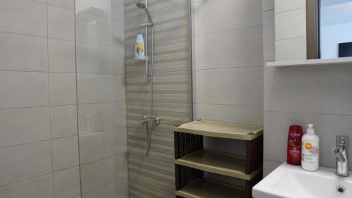 ein Bad mit einer Dusche und einem Waschbecken in der Unterkunft Luxury 1BR studio near Hanul Drumetului Bucharest in Bukarest