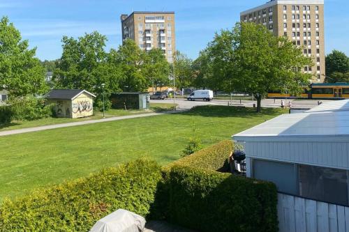 a grassy yard with buildings in a city at Entire Basement Level in Eneby in Norrköping