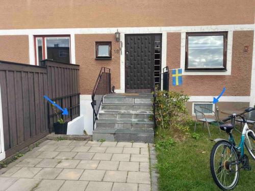 a bike parked in front of a house at Entire Basement Level in Eneby in Norrköping