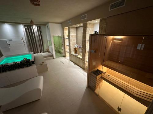 a large bathroom with a shower and a fish tank at Masseria Relais Santa Teresa in Sannicola
