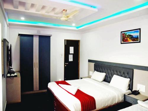 a bedroom with a bed with a red blanket at Hotel Hill View in Madikeri