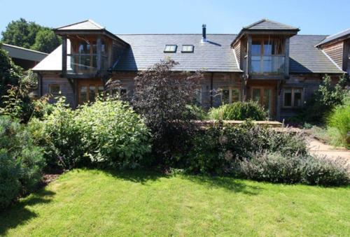 a large house with a garden in front of it at Horsham-Gatwick 16 miles Luxury-near Leonardslee in Horsham