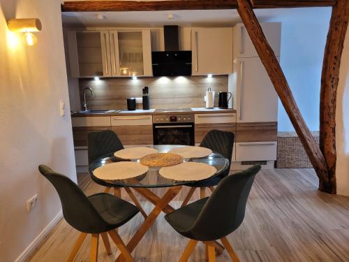 a kitchen and dining room with a table and chairs at FeWo Todeskino ''Strandgut'' in Heiligenhafen in Heiligenhafen