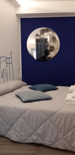 a bedroom with a bed with a moon on the wall at CalaLaNotte in Recanati
