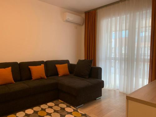 a living room with a couch and a large window at Luxury Apartments Newton by GLAM in Iaşi
