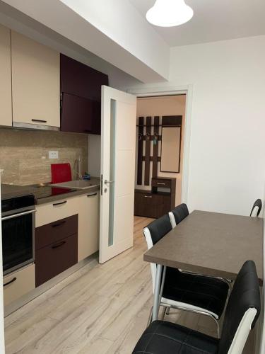 a kitchen and dining room with a table and chairs at Luxury Apartments Newton by GLAM in Iaşi