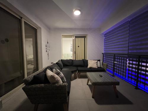 a living room with a couch and a table at Villa Marina Sea-View Private Pool in Peyia