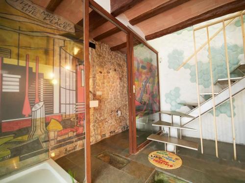 een kamer met een schilderij aan de muur en een trap bij Cal Jueu. Casa original. in Tarragona