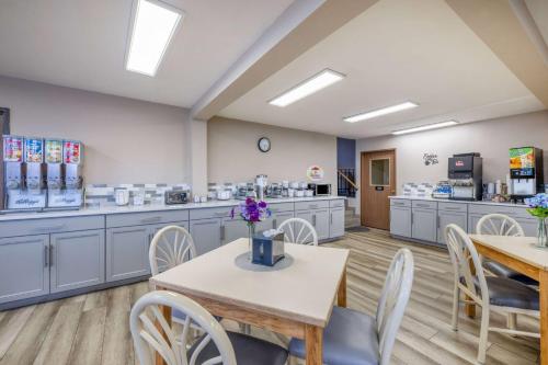 a room with tables and chairs in a clinic at Super 8 by Wyndham Butte MT in Butte