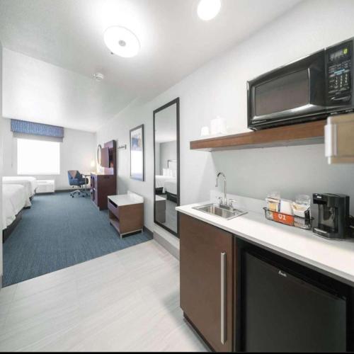 a hotel room with a kitchen and a living room at Hampton Inn & Suites Modesto - Salida in Modesto