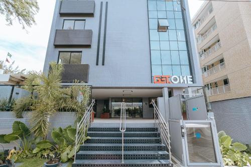 a building with stairs in front of a building at Flats na praia do Bessa in João Pessoa