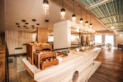 a bakery with a counter with baskets of bread at StayEasy Cape Town City Bowl in Cape Town