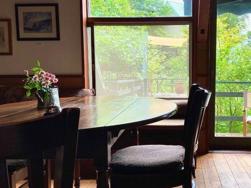 a dining room table with chairs and a window at Gallery HARA & GUESTHOUSE - Vacation STAY 68646v in Hara