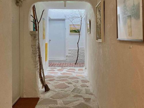 a hallway with a stone floor and an open door at Gallery HARA & GUESTHOUSE - Vacation STAY 68646v in Hara