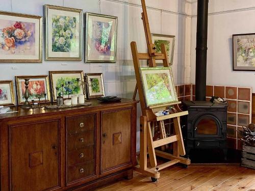 a painting room with a wood stove and paintings at Gallery HARA & GUESTHOUSE - Vacation STAY 68646v in Hara