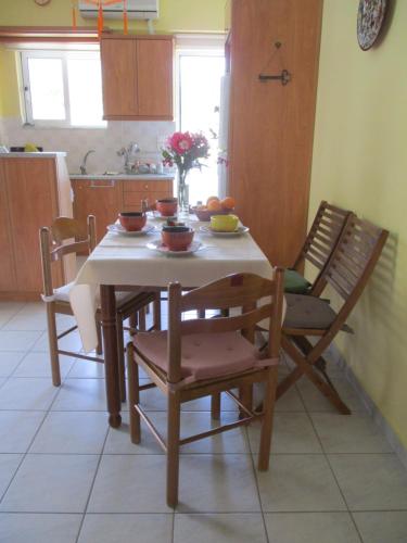 a kitchen with a table with bowls of fruit on it at Anna's Sweet Home Akrata in Paralía Akrátas