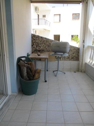 a room with a desk and a chair on a balcony at Anna's Sweet Home Akrata in Paralía Akrátas