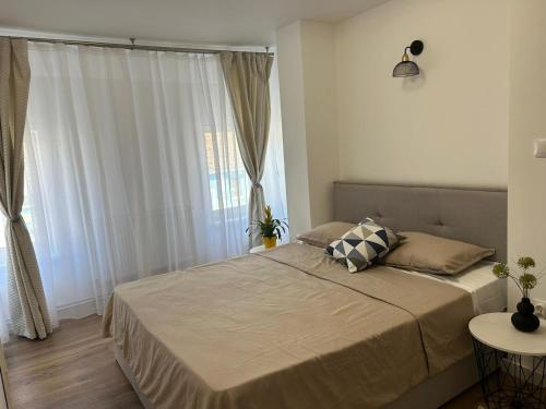 a bedroom with a bed with a large window at Cluj Home due in Cluj-Napoca