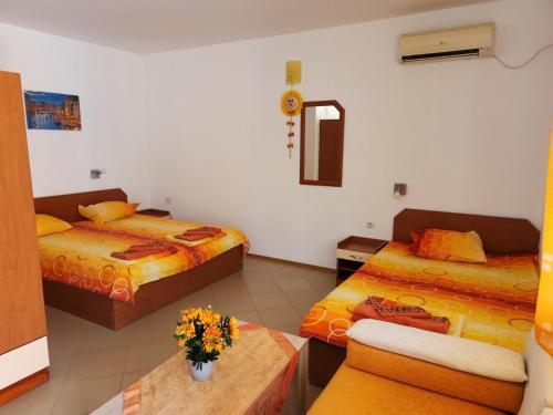 a hotel room with two beds and a table at Dom Zaharievi in Byala