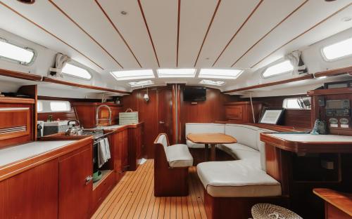 a kitchen with wooden cabinets and a table in a boat at BBoats in Lisbon
