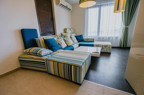 een woonkamer met een bank en een tafel bij Miletia Suites in Sozopol